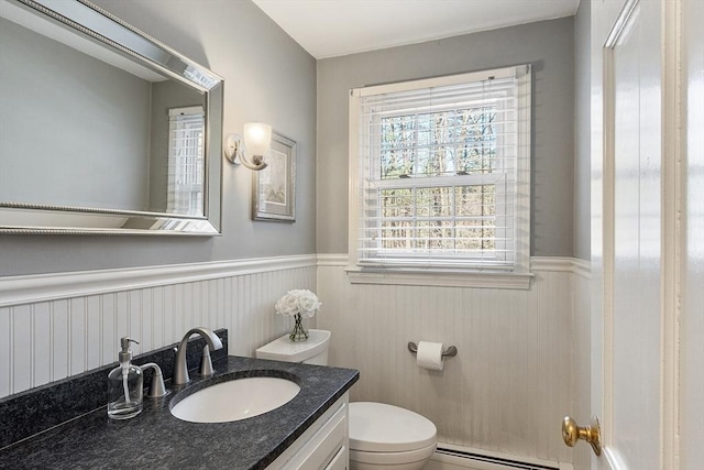 16 Kirsi Cir, Westford, MA 01886 - bathroom with a baseboard heating unit, a wainscoted wall, vanity, and toilet