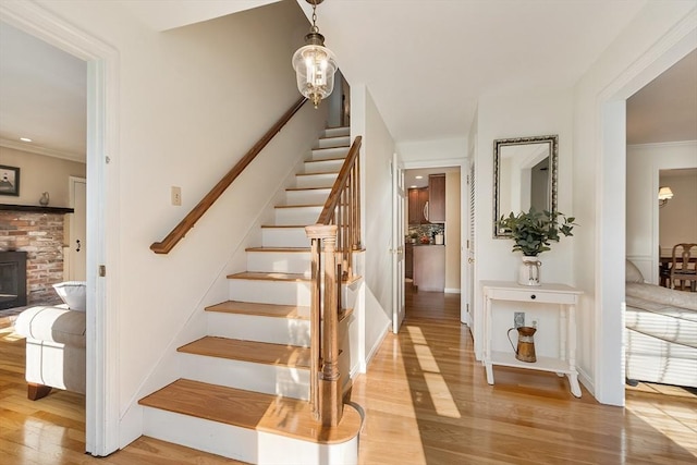 16 Kirsi Cir, Westford, MA 01886 - stairs featuring wood finished floors, ornamental molding, and baseboards