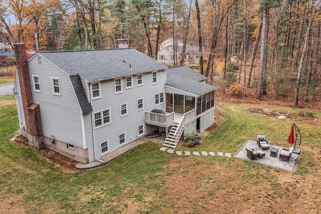 16 Kirsi Cir, Westford, MA 01886 - back of house featuring a sunroom, a shingled roof, a chimney, a patio area, and an outdoor hangout area