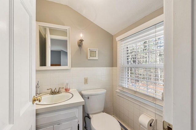 16 Kirsi Cir, Westford, MA 01886 - half bath with tile walls, vaulted ceiling, toilet, vanity, and wainscoting