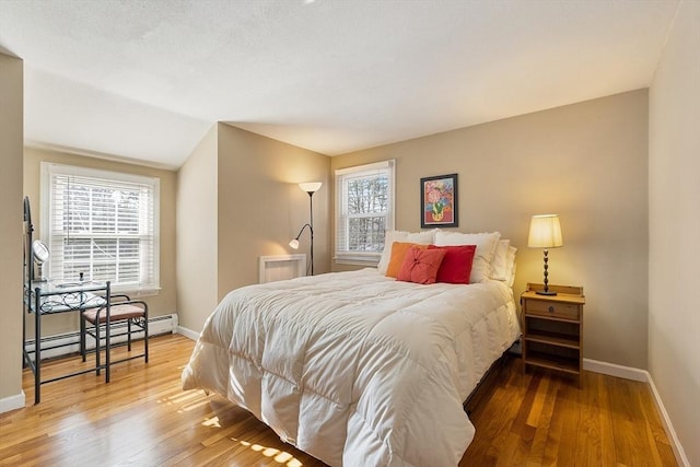 16 Kirsi Cir, Westford, MA 01886 - bedroom featuring a baseboard radiator, baseboards, wood finished floors, and lofted ceiling