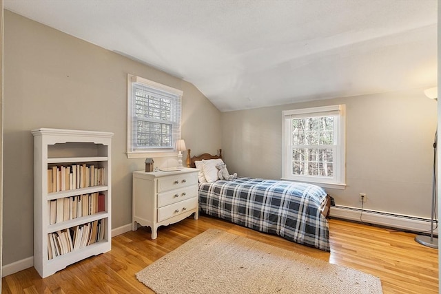 16 Kirsi Cir, Westford, MA 01886 - bedroom featuring a baseboard radiator, vaulted ceiling, wood finished floors, and baseboards