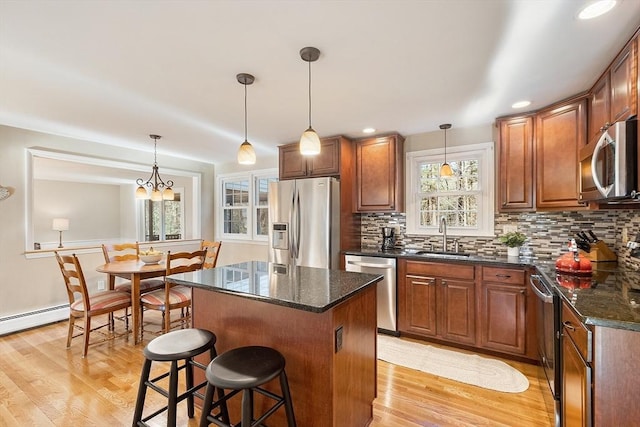 16 Kirsi Cir, Westford, MA 01886 - kitchen with stainless steel appliances, a sink, light wood-style flooring, a center island, and recessed lighting