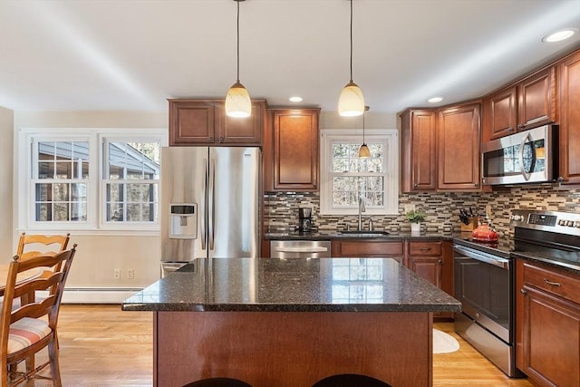 16 Kirsi Cir, Westford, MA 01886 - kitchen featuring stainless steel appliances, a sink, a kitchen island, decorative backsplash, and recessed lighting