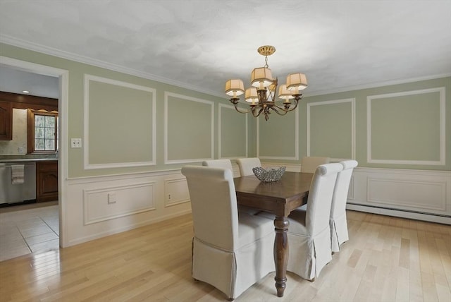 dining space featuring an inviting chandelier, a decorative wall, and light wood-type flooring