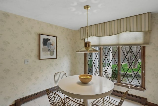 dining space featuring baseboards, a baseboard radiator, and light tile patterned flooring
