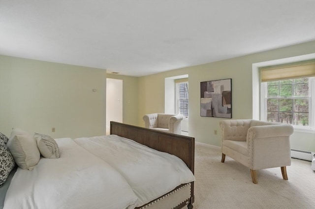bedroom featuring baseboards, light colored carpet, and baseboard heating