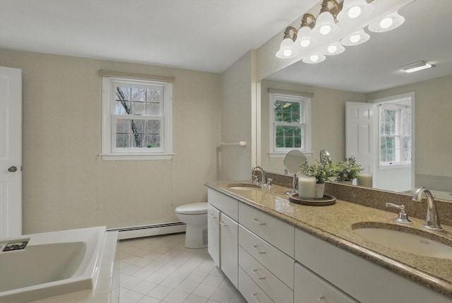 full bath with a sink, a baseboard heating unit, and a healthy amount of sunlight