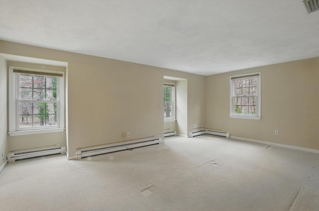empty room with visible vents, carpet, and a baseboard heating unit