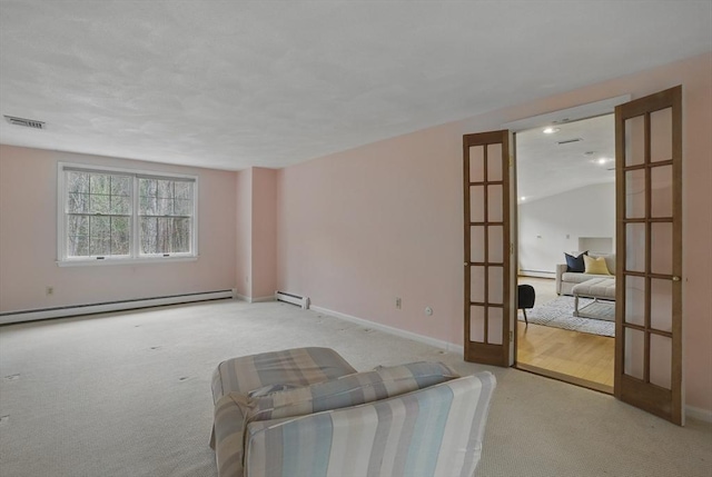 unfurnished living room featuring french doors, visible vents, baseboard heating, and carpet