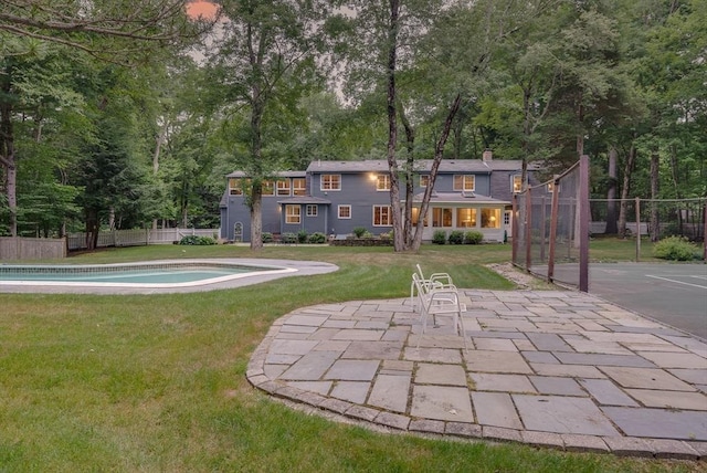 exterior space featuring a fenced in pool, fence, and a patio area
