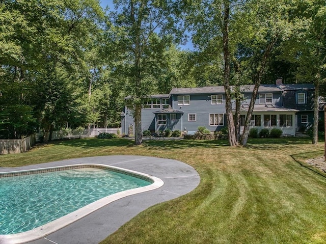 view of pool with a fenced in pool, a lawn, and fence
