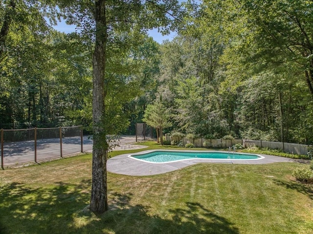 view of swimming pool featuring a yard, fence, and a fenced in pool