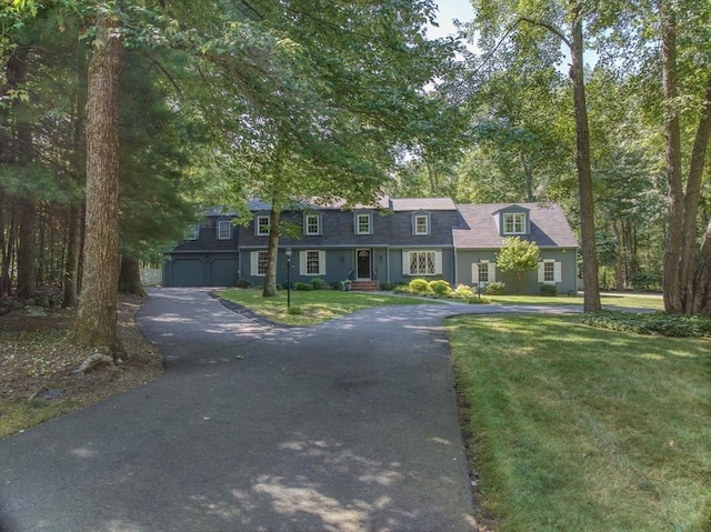 view of front of house featuring a front yard and aphalt driveway