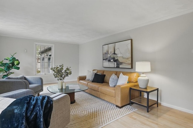 living area with crown molding, baseboards, and wood finished floors