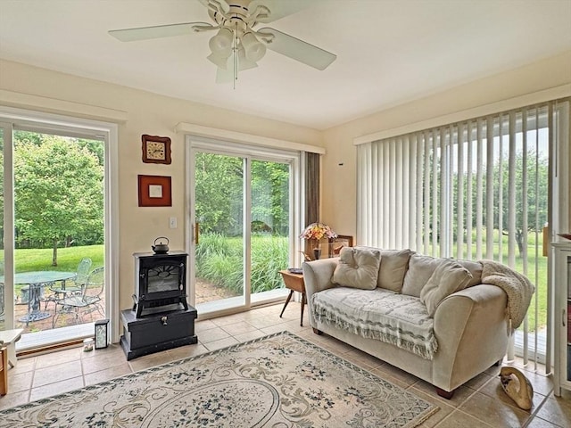 5 Boyle Rd, Gill, MA 01354 - living area with a wood stove, ceiling fan, healthy amount of natural light, and light tile patterned floors