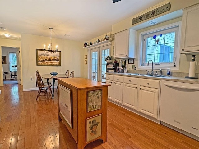 5 Boyle Rd, Gill, MA 01354 - kitchen featuring white dishwasher, hardwood / wood-style flooring, a chandelier, french doors, and white cabinets