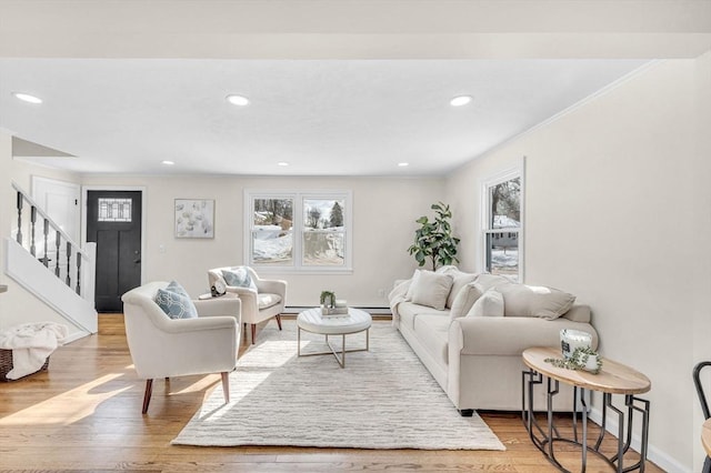 living area with stairs, recessed lighting, wood finished floors, and crown molding