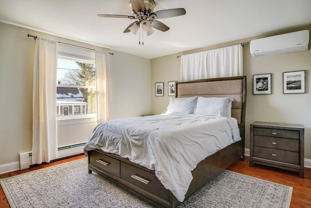 bedroom with ceiling fan, an AC wall unit, a baseboard radiator, and wood-type flooring