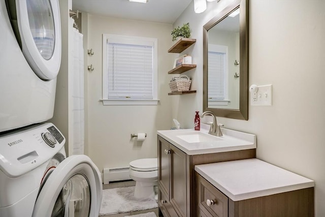 bathroom with baseboard heating, toilet, vanity, and stacked washer and dryer