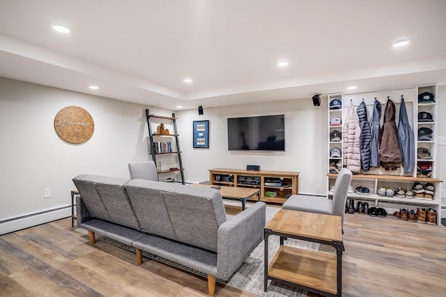 living room with wood-type flooring and a baseboard radiator