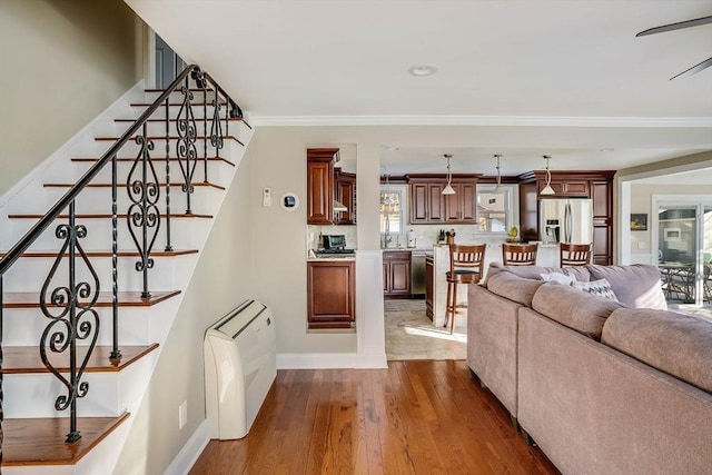 living room featuring crown molding and hardwood / wood-style floors