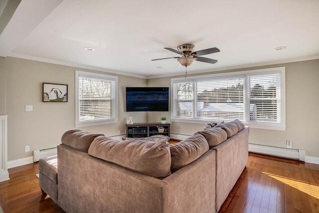 living room featuring a baseboard heating unit, a wealth of natural light, and hardwood / wood-style flooring