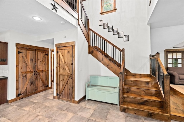3 Side Hill Rd, Hingham, MA 02043 - stairway featuring baseboards, a barn door, and a towering ceiling