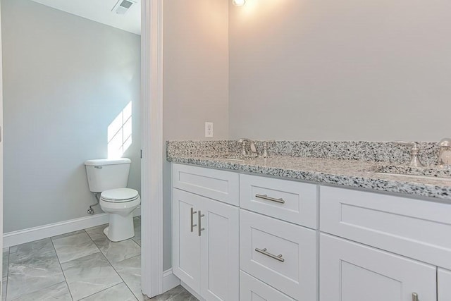 71 Pouts Ln Unit 0, Uxbridge, MA 01569 - bathroom featuring marble look tile flooring, double vanity, toilet, and baseboards