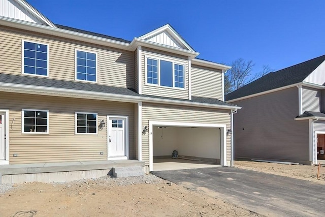 71 Pouts Ln Unit 0, Uxbridge, MA 01569 - view of front of home featuring an attached garage, driveway, and board and batten siding