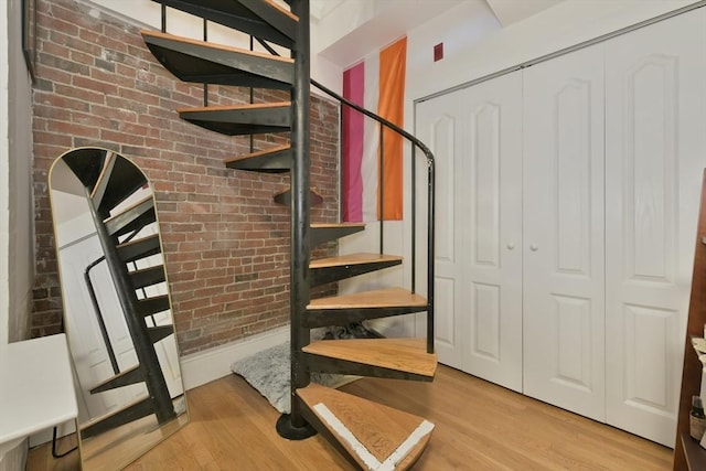 279 Beacon St Unit 1, Boston, MA 02116 - staircase featuring wood finished floors and brick wall