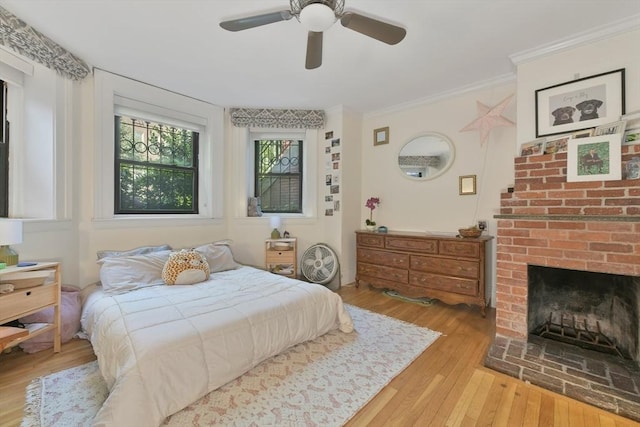 279 Beacon St Unit 1, Boston, MA 02116 - bedroom featuring hardwood / wood-style flooring, crown molding, a brick fireplace, and a ceiling fan