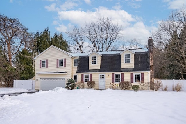 dutch colonial with a garage, fence, and a shingled roof