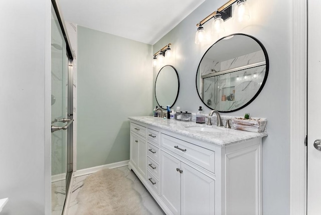 full bath with marble finish floor, a marble finish shower, baseboards, and a sink