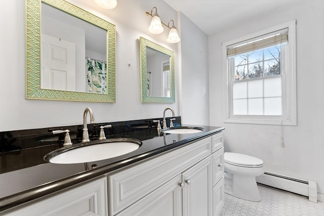 full bath with a baseboard heating unit, a sink, toilet, and double vanity