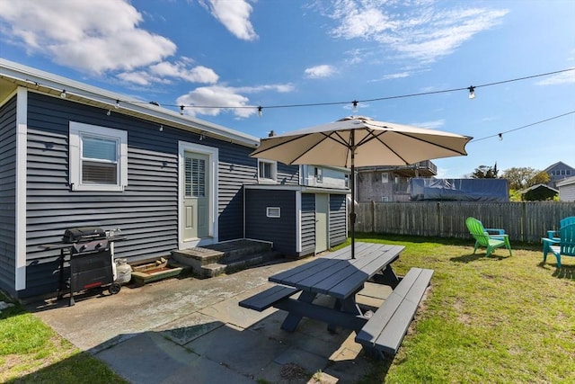 rear view of house featuring an outdoor structure, a patio, and a storage shed