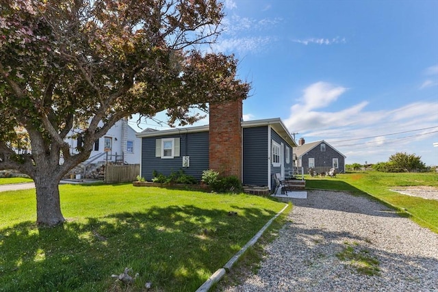 view of front of property featuring a front lawn and a chimney