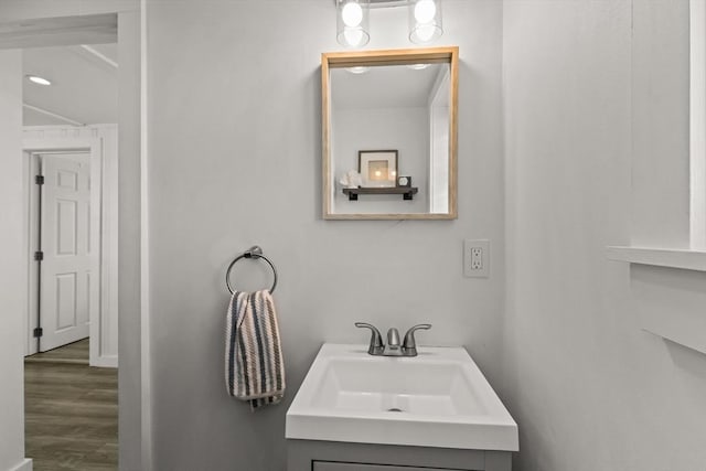 bathroom featuring wood finished floors, vanity, and recessed lighting