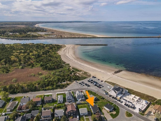aerial view of property's location with unending shoreline and nearby suburban area