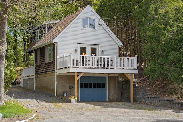 4 Agawam Ave, Ipswich, MA 01938 - rear view of property featuring an attached garage, a wooden deck, driveway, and a shingled roof