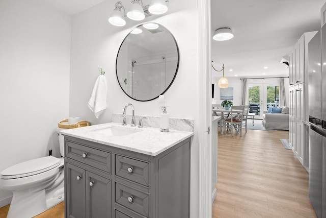 4 Agawam Ave, Ipswich, MA 01938 - bathroom with french doors, wood finished floors, toilet, and vanity