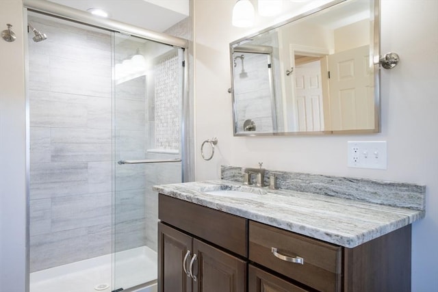 bathroom featuring a stall shower and vanity