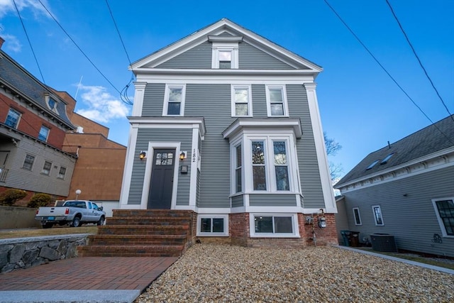 neoclassical home featuring central AC unit