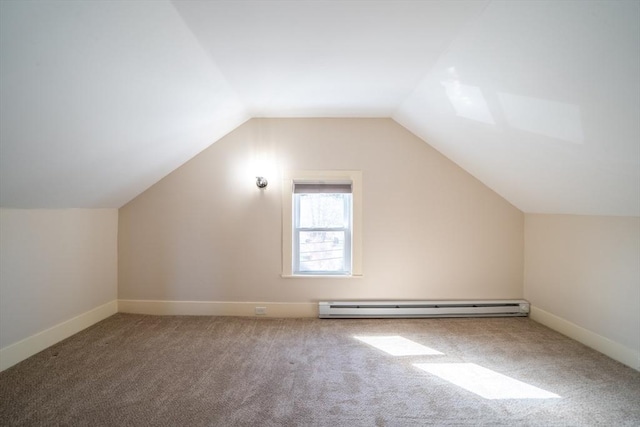 bonus room featuring a baseboard heating unit, lofted ceiling, baseboards, and carpet