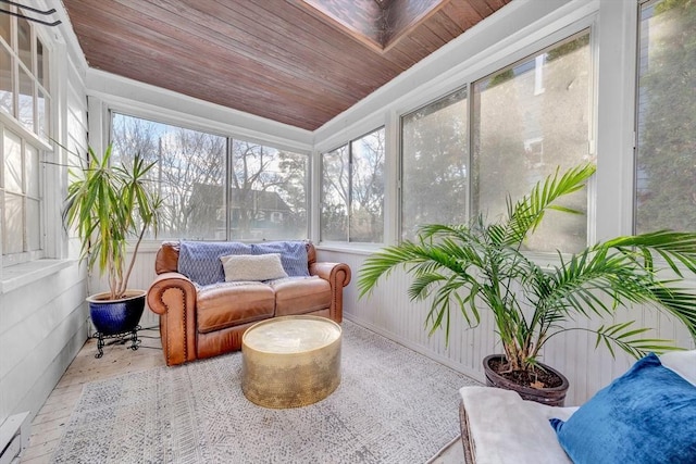 sunroom / solarium with wood ceiling, plenty of natural light, and a baseboard heating unit