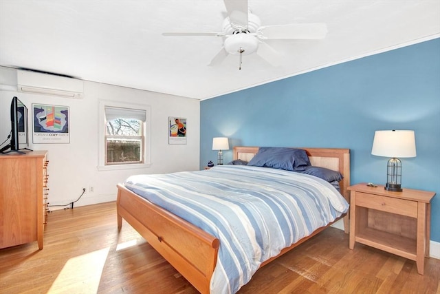 bedroom featuring an AC wall unit, hardwood / wood-style floors, and ceiling fan