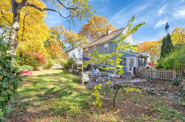 view of yard with a sunroom and a patio