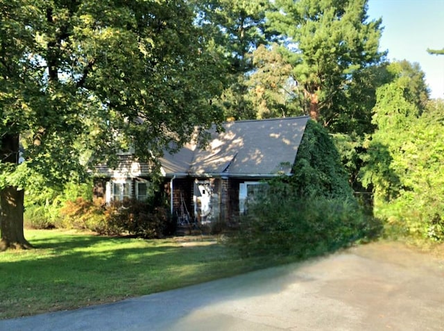 obstructed view of property featuring a front yard