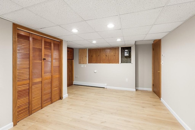 interior space featuring recessed lighting, baseboards, a baseboard heating unit, and light wood-style floors