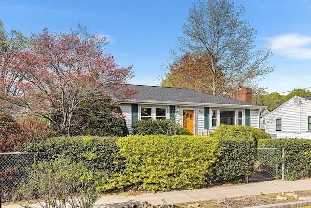 view of front of home with fence and a chimney